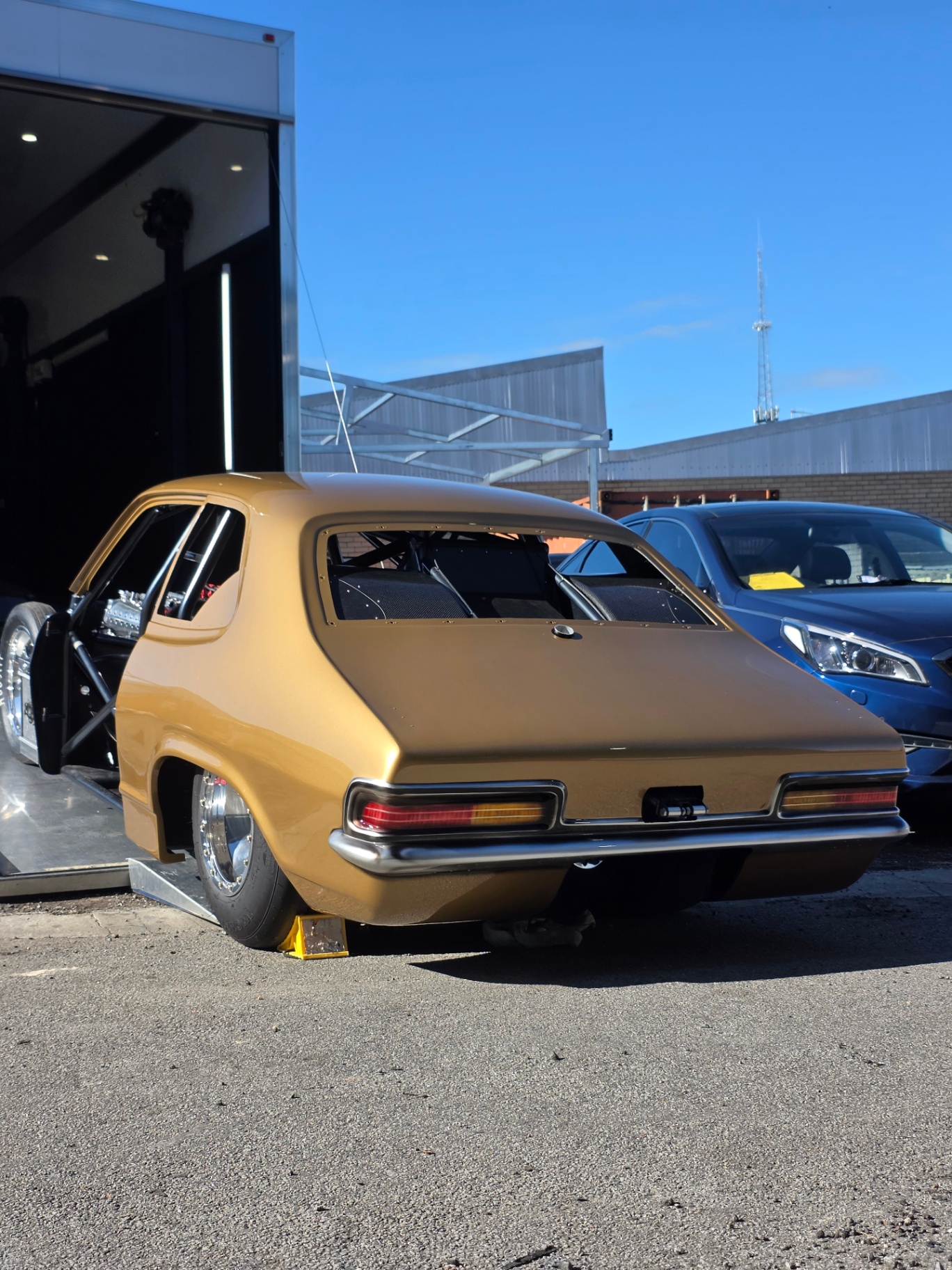 Gold drag car build leaving the enclosed trailer