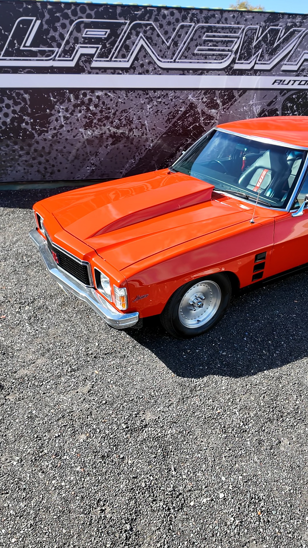 Orange classic muscle car undergoing restoration at Laneway Nostalgia