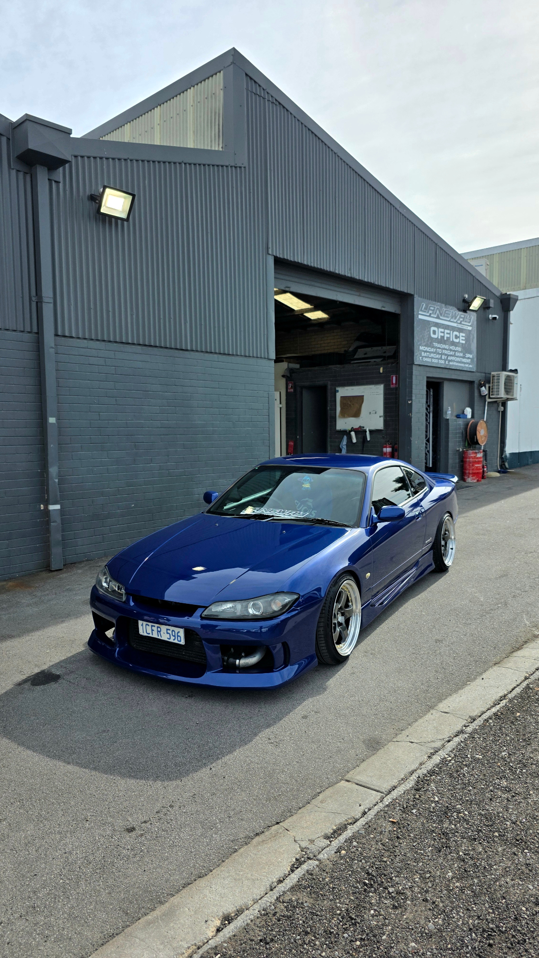 Blue Nissan Silvia S15 front three-quarter outside the office