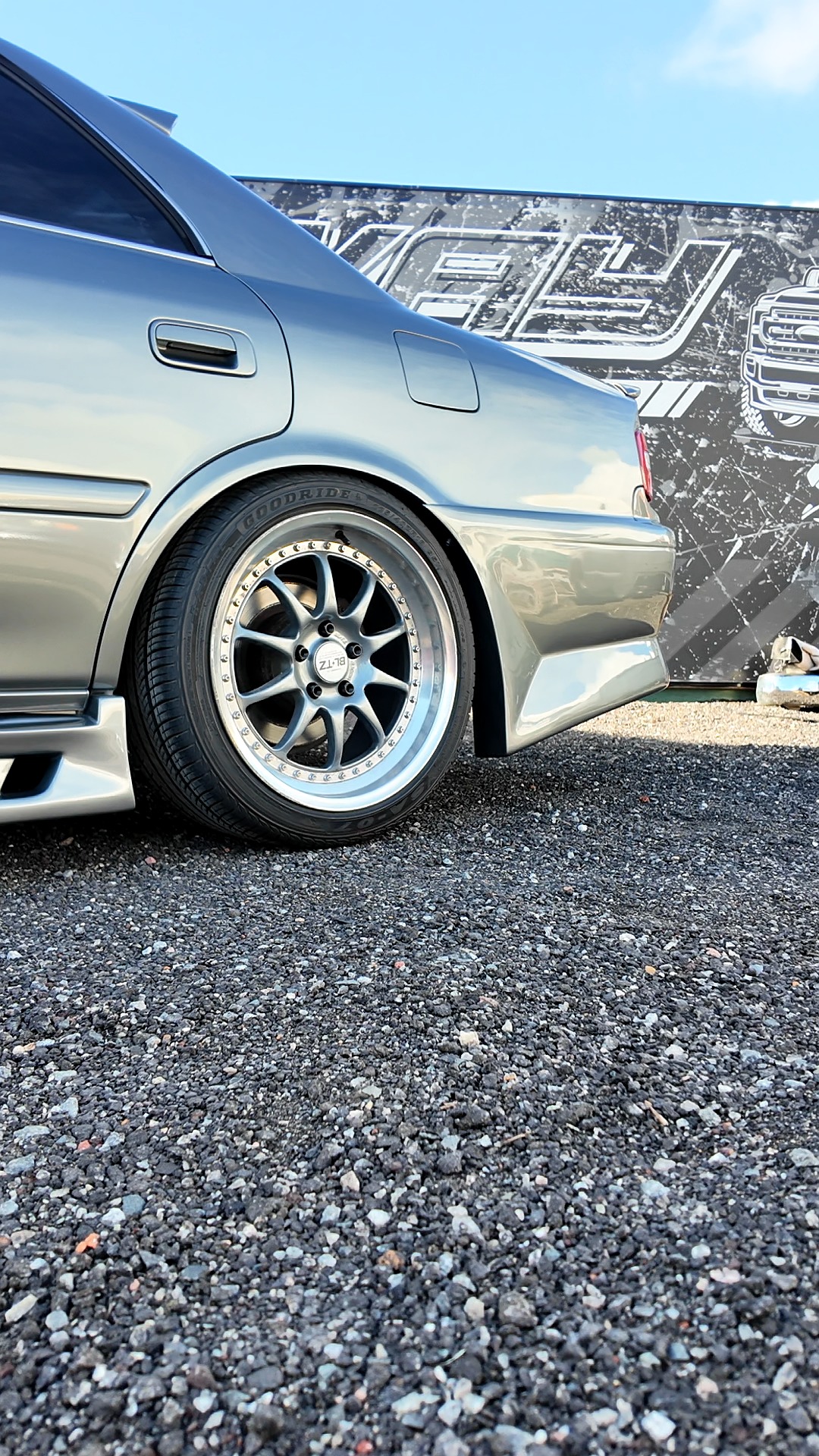 Silver JDM sedan rear quarter on wheels